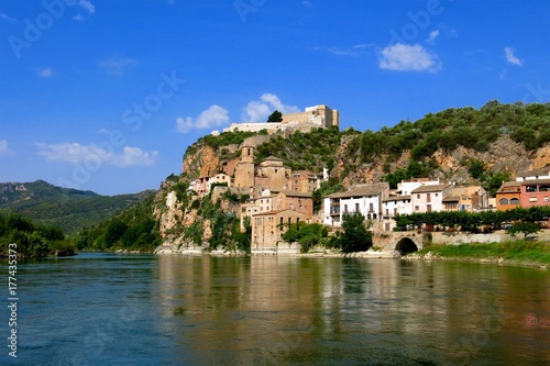 Miravet, Catalonia, Spain on Ebro River. Medieval castle once occupied by the Knights Templar towers over village.