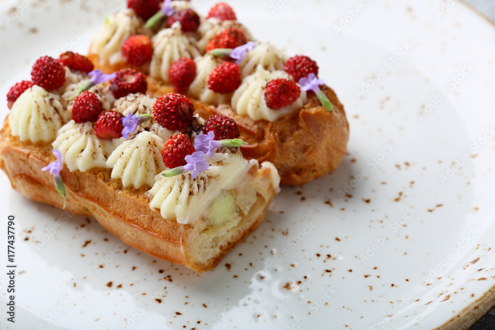 French eclair with cream on plate French eclair with cream on plate