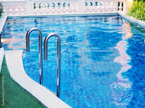Modern metal ladder to swimming pool.