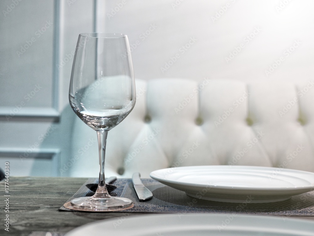 Table set with wineglass, dish, spoon and knife for romantic lunch or dinner. Table set with wineglass, dish, spoon and knife for romantic lunch or dinner.