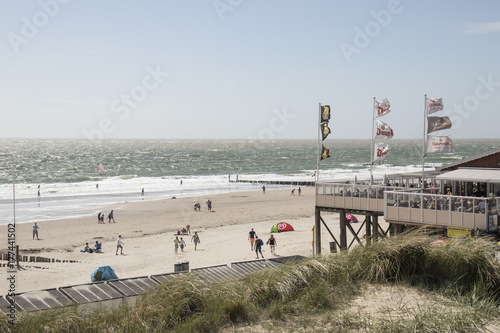 People play on the beach in the storm
