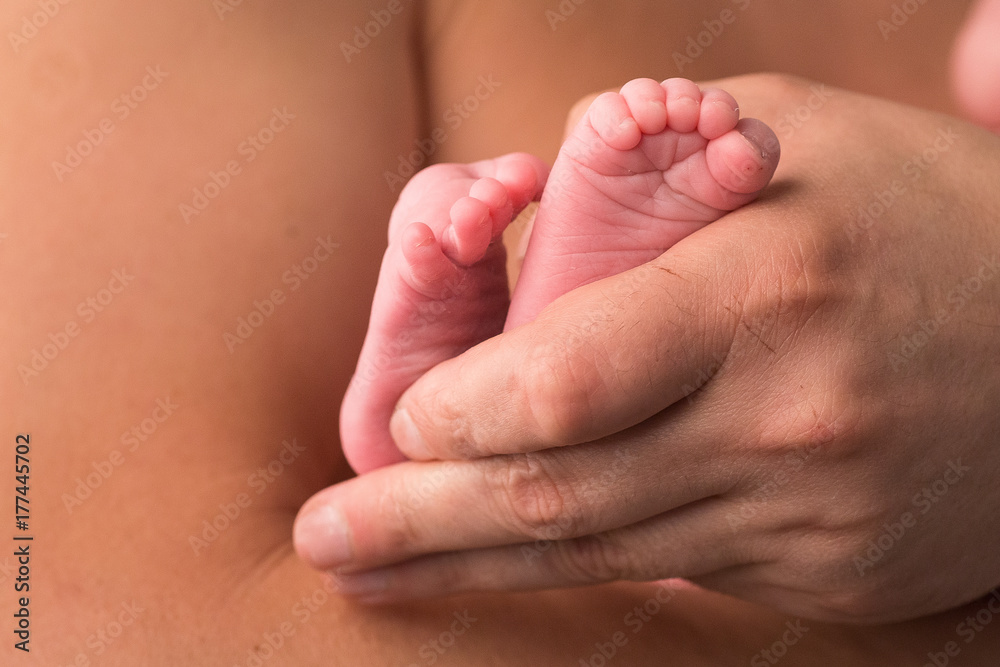 Feet newborn baby in mother's palm. Soft image of beautiful family. Feet newborn baby in mother's palm. Soft image of beautiful family.