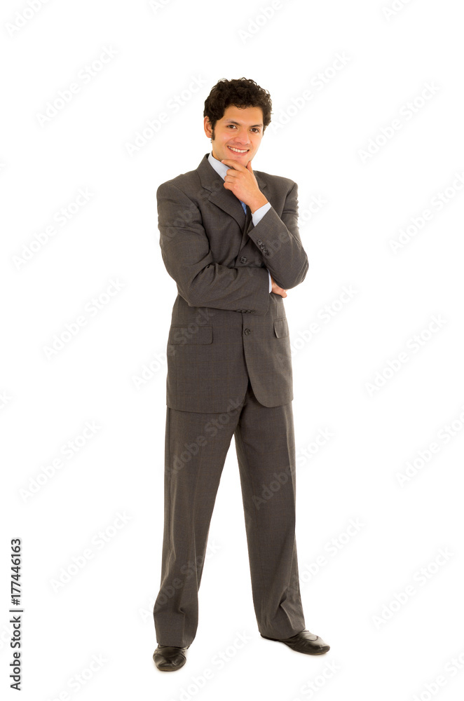 Full length of a handsome young man with curly hair, wearing a nice suit, and posing in a white background Full length of a handsome young man with curly hair, wearing a nice suit, and posing in a white background