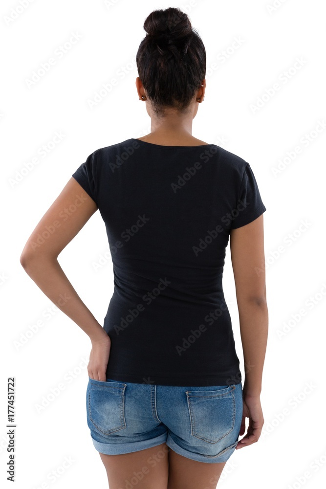Rear view of young woman with hand in pocket Rear view of young woman with hand in pocket