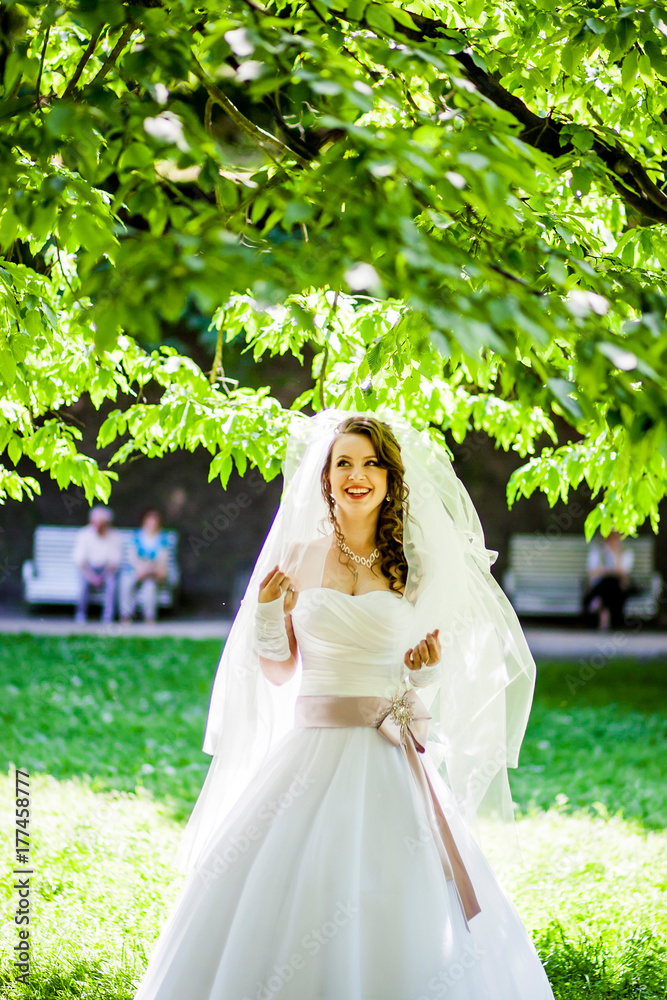 Cute bride in white dress poses Cute bride in white dress poses