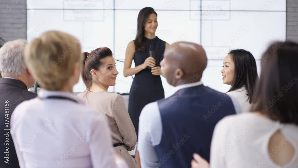 Business group clapping motivational speaker at business seminar Business group clapping motivational speaker at business seminar
