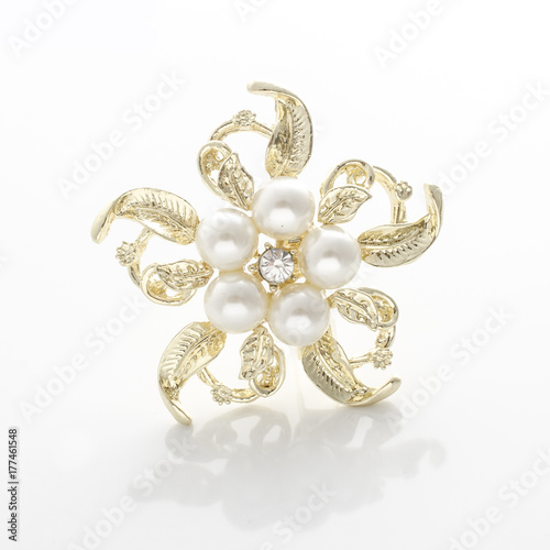 silver brooch flower with pearl isolated on black