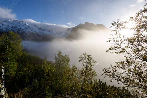 panoramic view of of mountains in misty forest © Martins Vanags