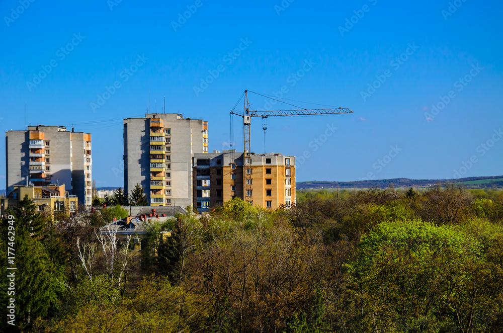 Fototapeta premium High construction crane against blue sky