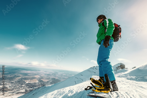 Snowboarder stay on the mountain top