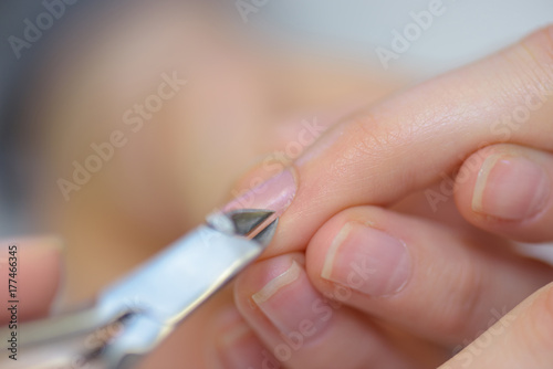 cutting nails using nail clipper
