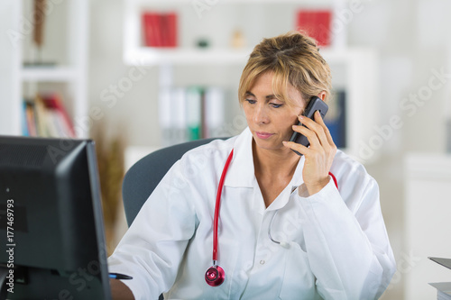 portrait of mature female doctor on the phone