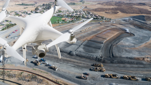 Unmanned Aircraft System (UAV) Quadcopter Drone In The Air Over Construction Site.