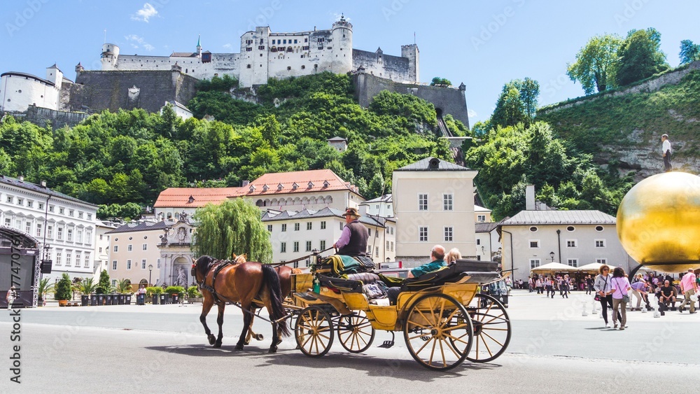 Tourists sightseeing in horse carriage in Salzburg, Austria - obrazy, fototapety, plakaty 