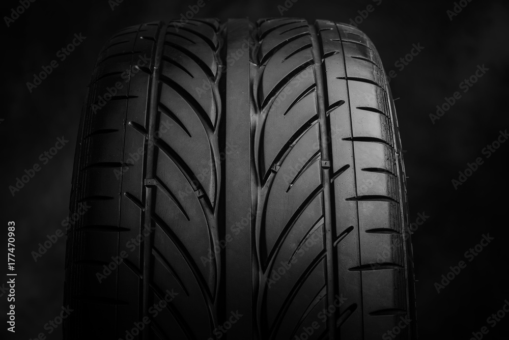 Car tires on a dark background.