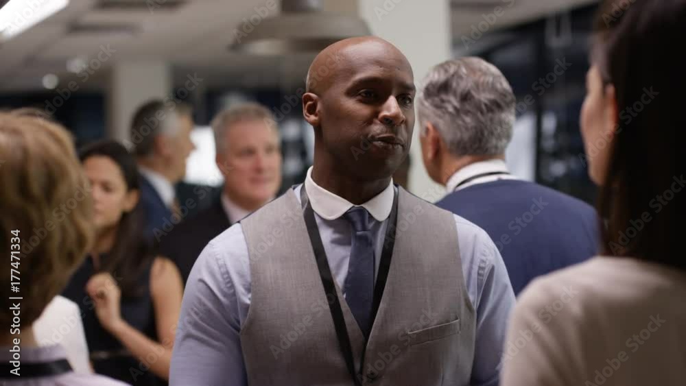 Diverse business group talking and networking at a business conference