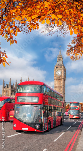 Buses with autumn leaves against Big Ben in London, England, UK