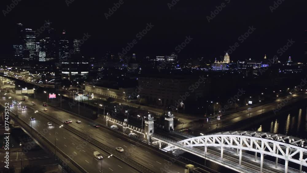 Aerial view of Luzhniki Metro Bridge, also known as Metromost, heavy traffic at night.Moscow river and city skyline during sunset. Big city life concept. Big city life concept. Aerial view of Luzhniki Metro Bridge, also known as Metromost, heavy traffic at night.Moscow river and city skyline during sunset. Big city life concept. Big city life concept.