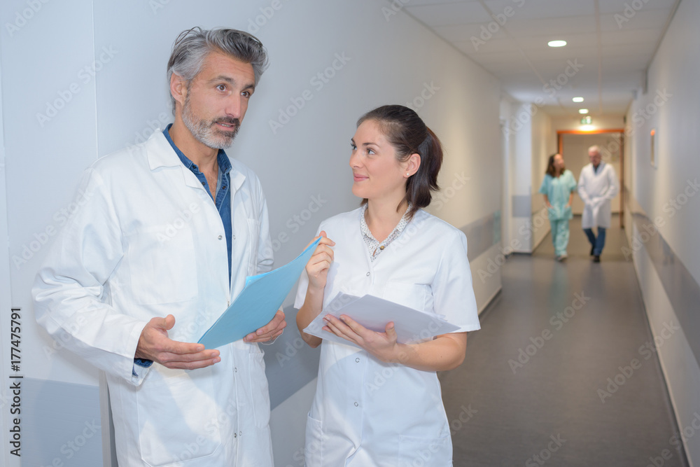 male doctor and female nurse in hospital corridor male doctor and female nurse in hospital corridor