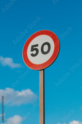 Round Speed Limit Road Sign Above Blue Sky