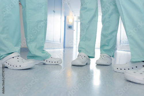 close up shoes of medical team in hospital corridor