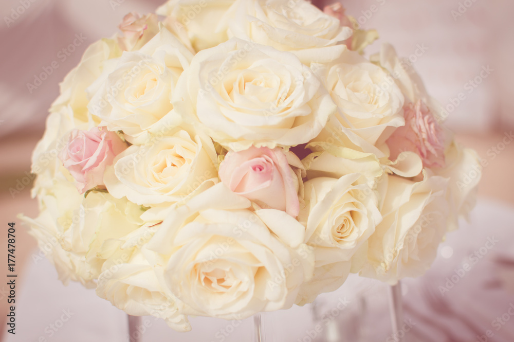 Close up on wedding flowers, bridal bouquet. Decoration made of roses over light celebration background Close up on wedding flowers, bridal bouquet. Decoration made of roses over light celebration background
