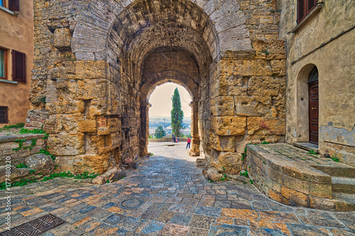 stone arch in street of Volterra