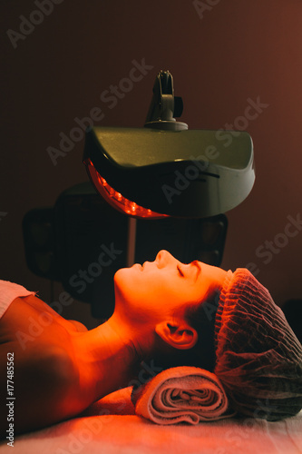 Woman in a Beauty Clinic Receiving a Facial Color Light Treatment photo