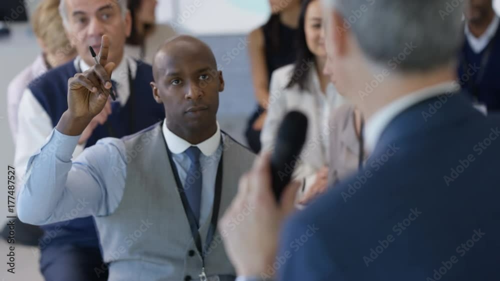 Speaker addressing the audience at a business seminar and answering questions