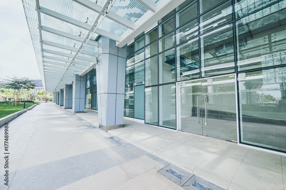 Modern empty office buildings with glass wall and empty pavement . Modern empty office buildings with glass wall and empty pavement .