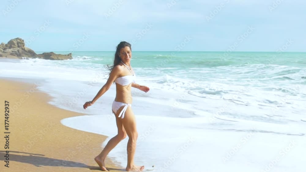 Slow motion of beautiful woman alone in an amazing and unspoiled beach in the spain coast Slow motion of beautiful woman alone in an amazing and unspoiled beach in the spain coast