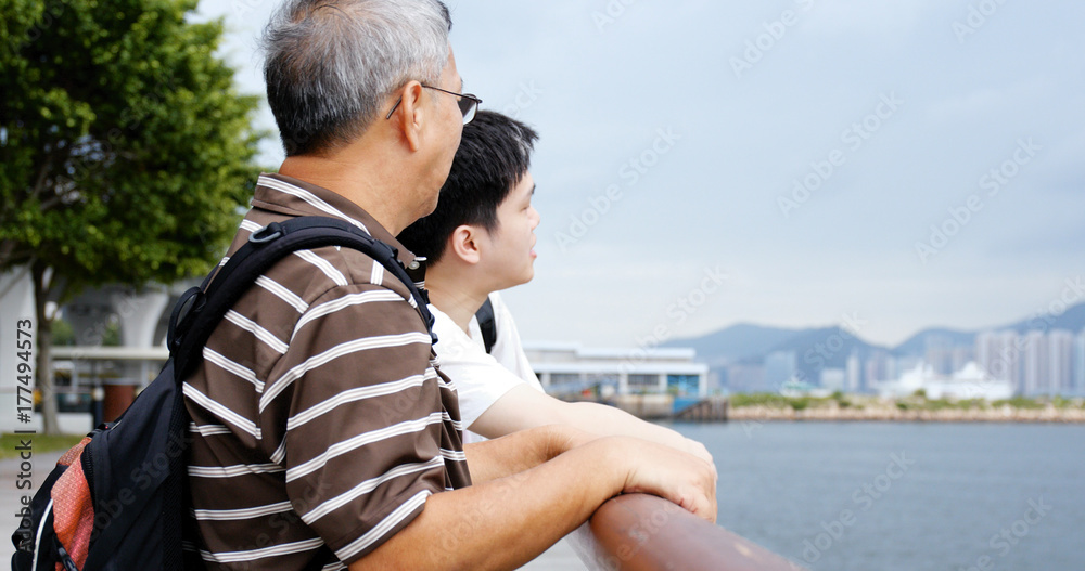 Father and son talking at sea side