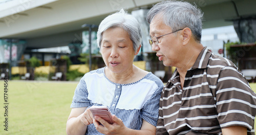 Photography Retired couple using mobile phone together