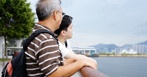 Father and son talking at sea side