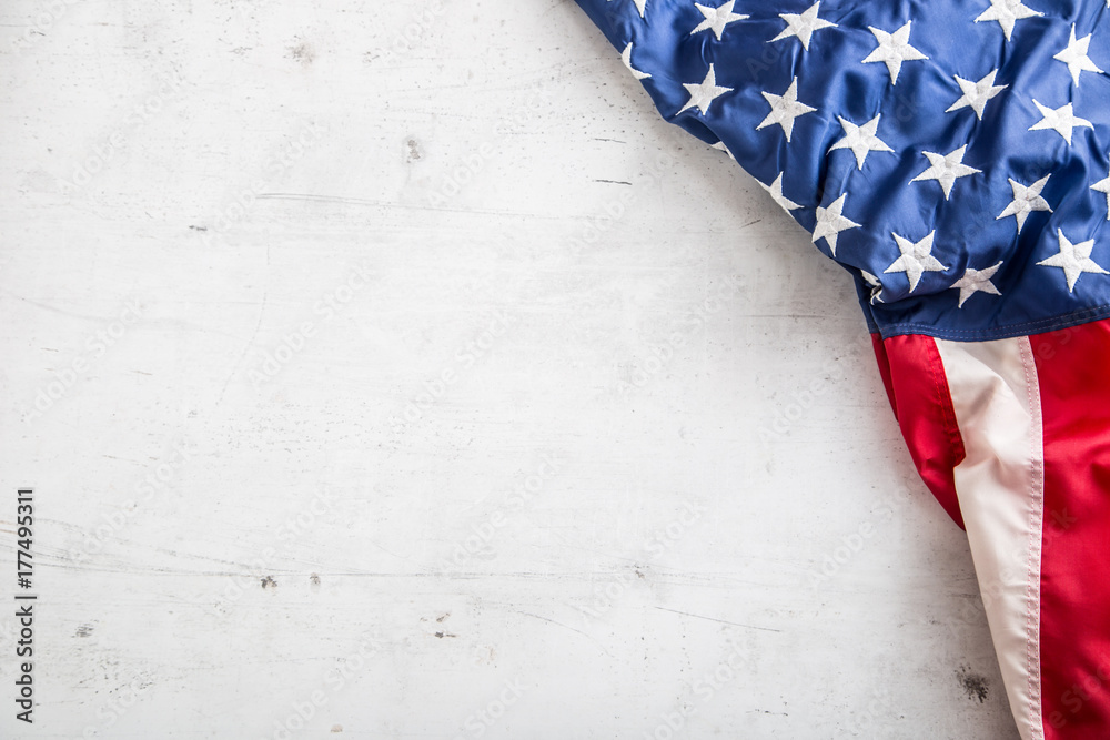 Fototapeta premium USA flag. American flag. Top of view American flag freely lying on white concrete background. Close-up Studio shot