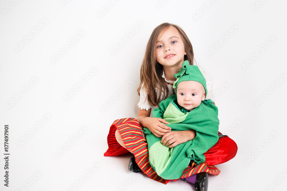 Sister holding baby brother wearing Halloween Costumes Sister holding baby brother wearing Halloween Costumes