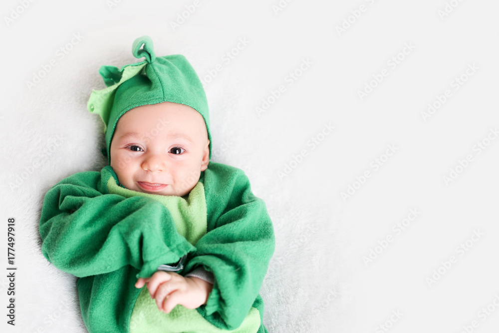 Baby dressed up in a dinosaur costume for Halloween