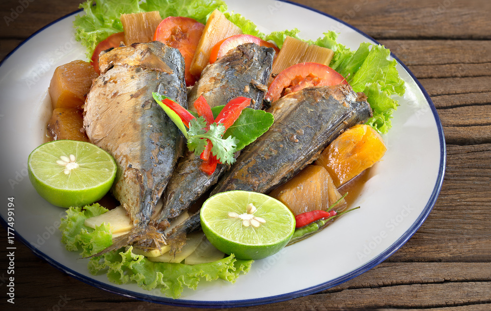 Mackerel boiled sweet and salted on white dish Thai food on old wooden table Mackerel boiled sweet and salted on white dish Thai food on old wooden table