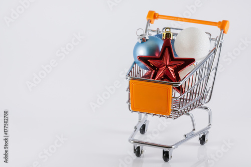 Tiny shopping trolley full of Christmas baubles