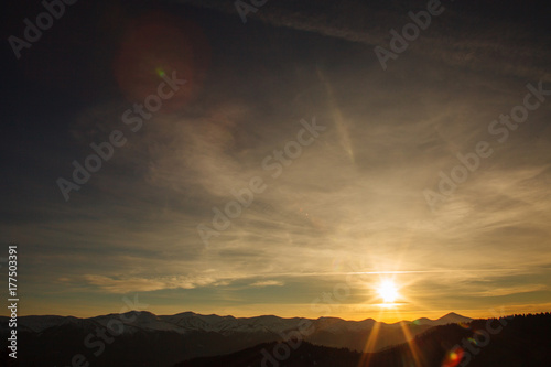 Sunset over the mountain range. fantasy sky and mountains landscape.