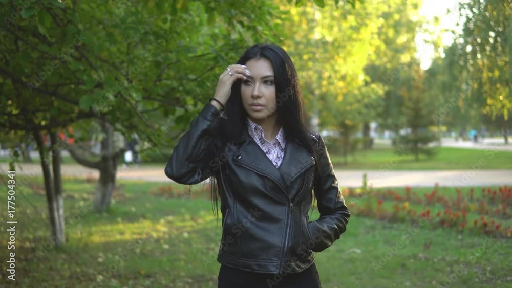 beautiful young girl walking in summer park against background beautiful young girl walking in summer park against background
