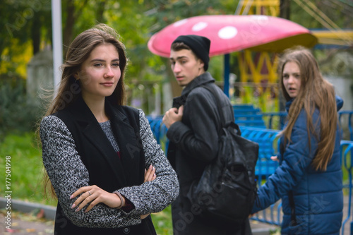 Disloyal man walking with girlfriend and looking amazed at another seductive girl