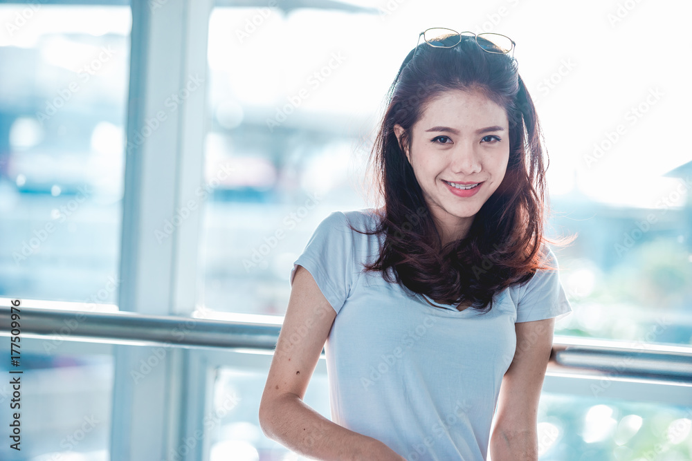 Asian teen girl are going to the platform for check-in to buy plane tickets to travel abroad on weekends. Asian teen girl are going to the platform for check-in to buy plane tickets to travel abroad on weekends.
