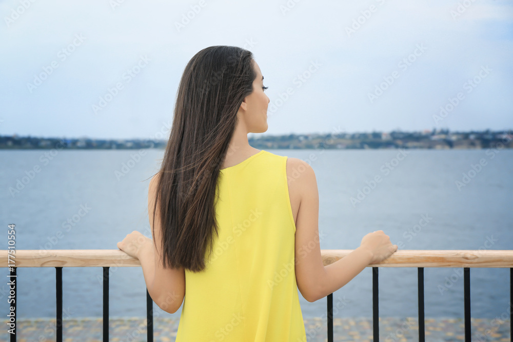 Young woman relaxing near river