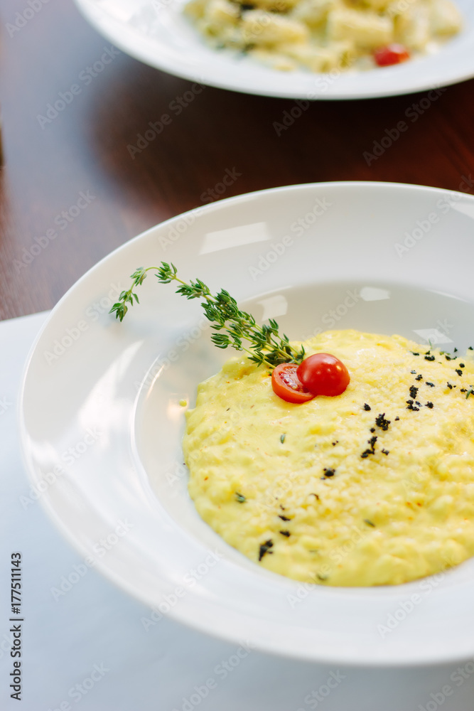 Italian food - delicious traditional risotto in a white plate. Italian food - delicious traditional risotto in a white plate.