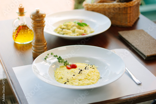 Italian food - delicious traditional risotto in a white plate.