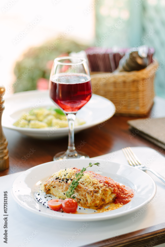 Lasagne in tomato sauce with red wine at italian food restaurant. Lasagne in tomato sauce with red wine at italian food restaurant.