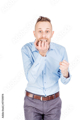 business man biting his nails fingers freaking out. human emotion expression and lifestyle concept. image on a white studio background..