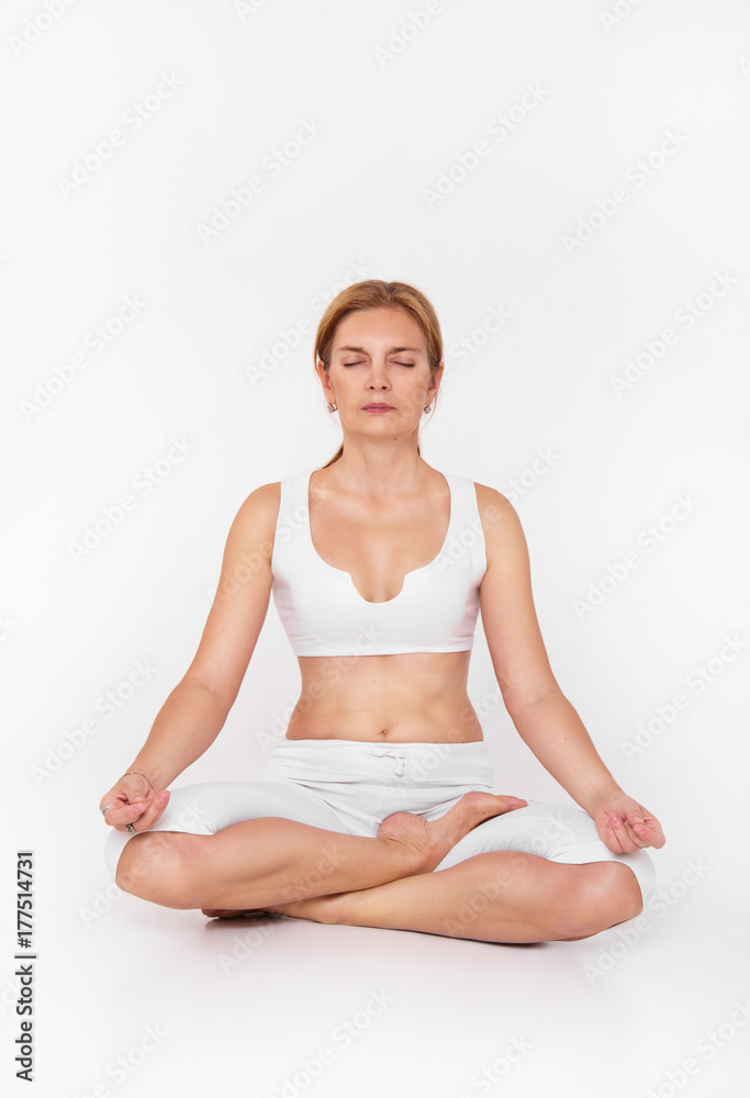 Adult woman doing yoga. Beautiful woman sitting in meditation yoga pose  Stock Photo