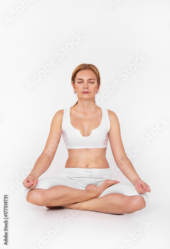 Adult woman doing yoga. Beautiful woman sitting in meditation yoga pose